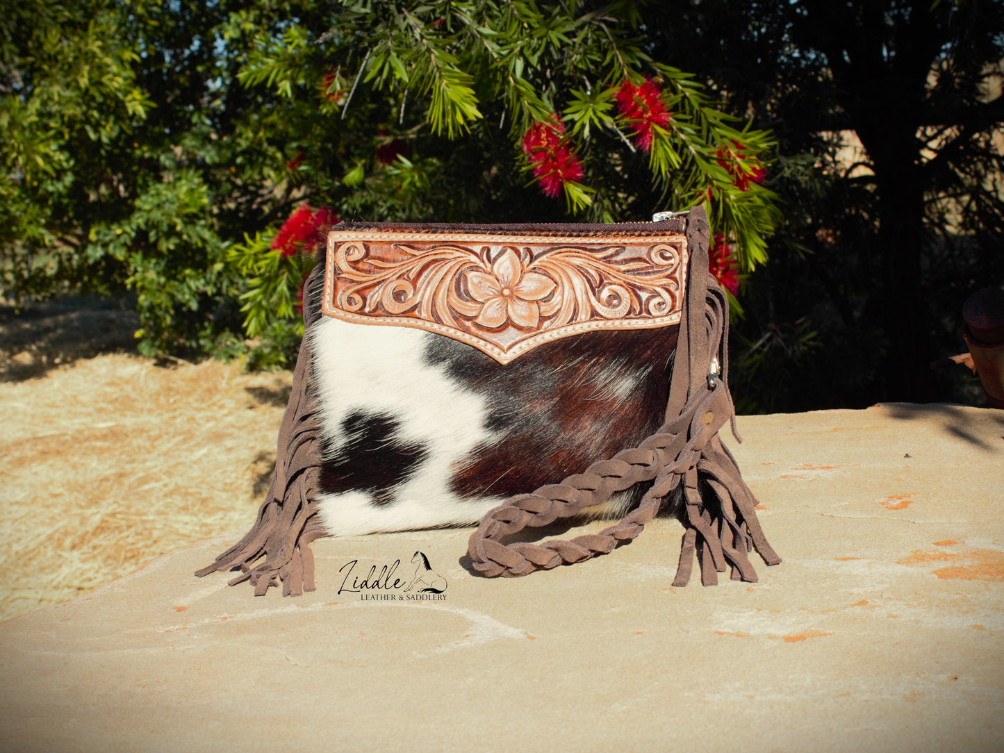 Cowhide and Tooled Wristlet purse.