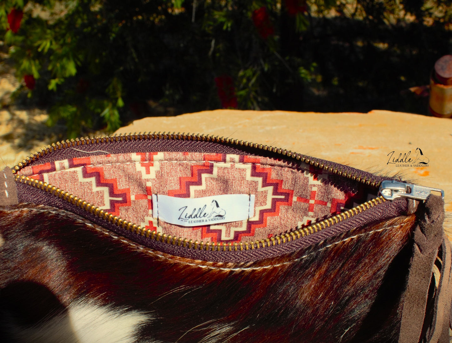 Cowhide and Tooled Wristlet purse.