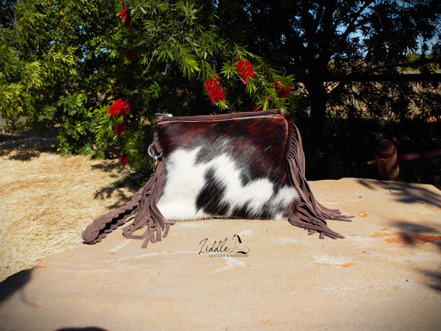 Cowhide and Tooled Wristlet purse.